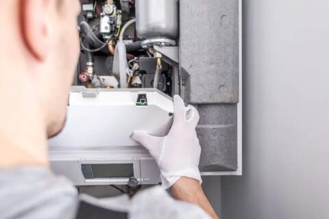 technician repairing furnace