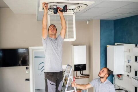 technician installing air conditioner