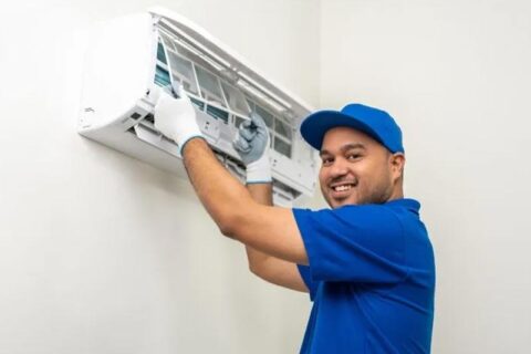 technician cleaning air conditioner