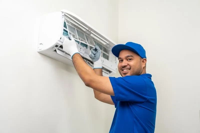 technician cleaning air conditioner