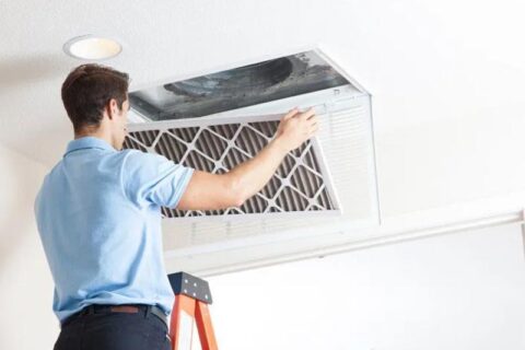 technician cleaning air duct