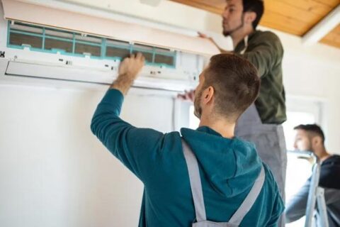 technician adjusting ac blades