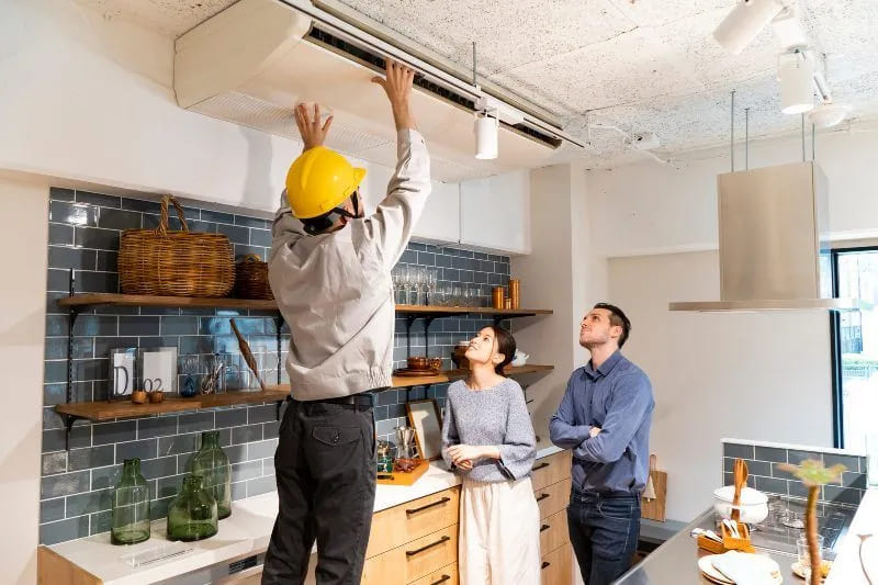 technician examining air conditioner