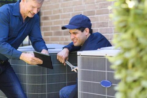 repair workers fixing ac compressor