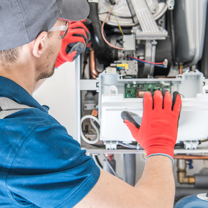 man inspecting furnace