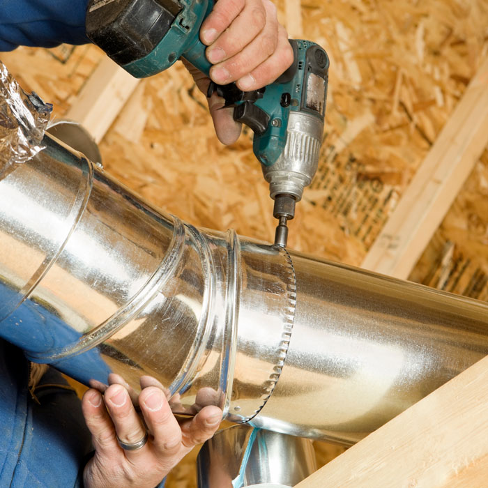 man sealing air duct