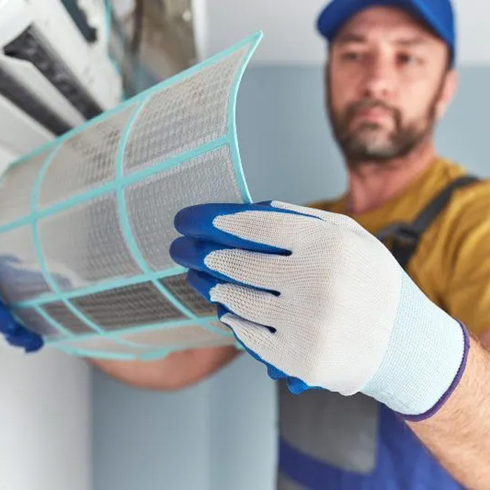 man inspecting filter for ductless mini split