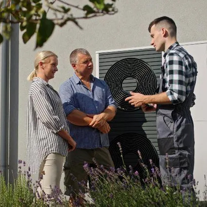 technician explaining information to home owners