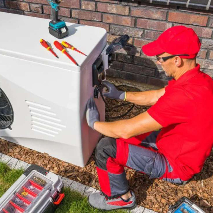 Man examining heat pump
