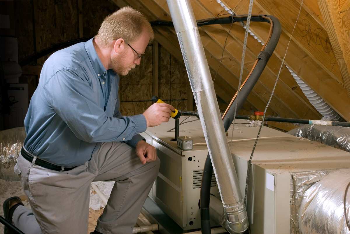 Technician Inspecting Furnace Blower Motor in Volusia & Flagler Counties, FL