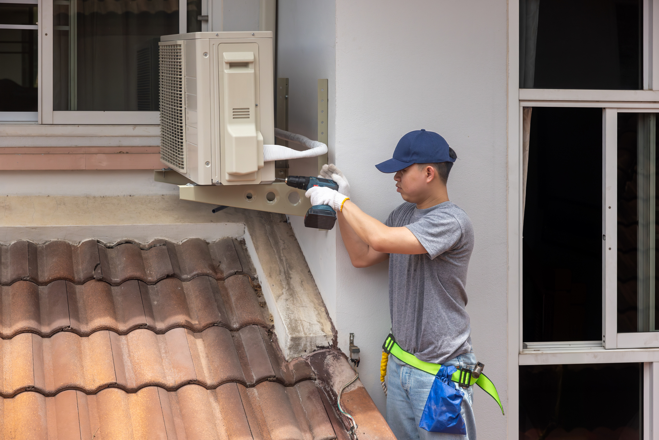 Technician handles outdoor unit installation for heater replacement in Volusia and Flagler Counties