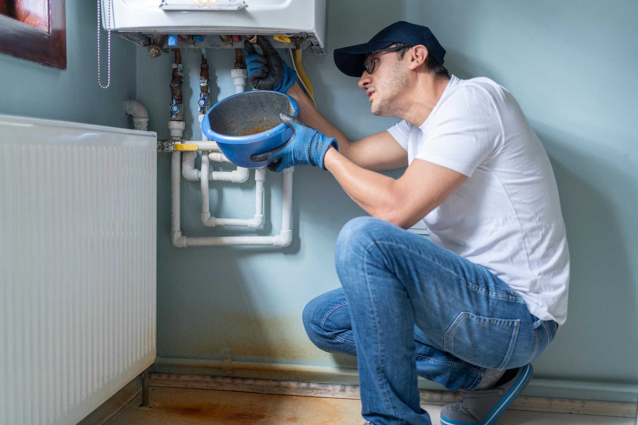 Technician checking heating system before replacement in Volusia and Flagler Counties