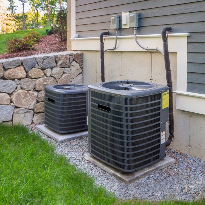 Two air conditioning units installed outside a residential home in Volusia and Flagler Counties, FL.